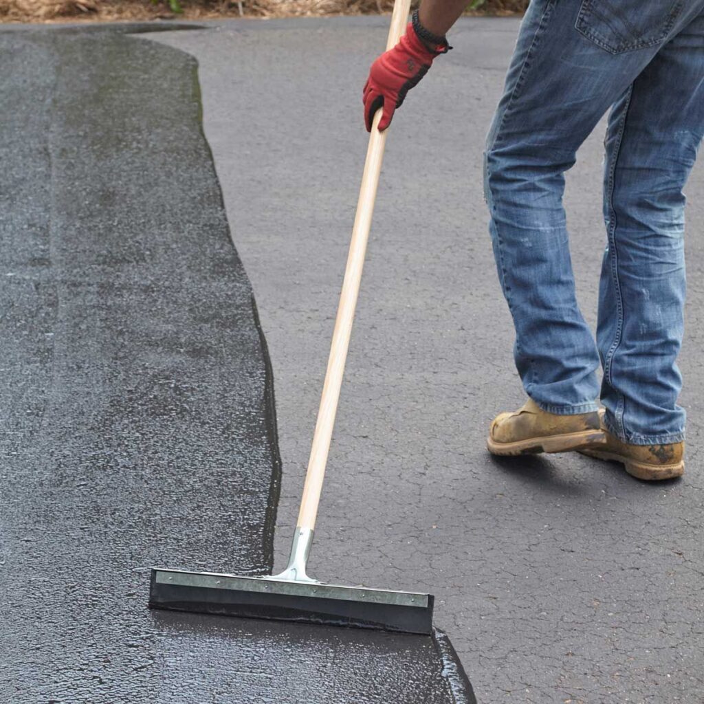 Driveway being protected and maintained with sealer