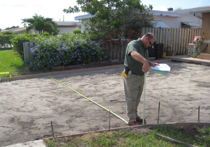 Man inspecting a driveway before work is done