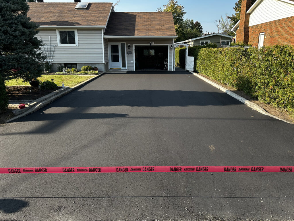Freshly paved driveway with caution tape